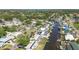 Aerial view of the neighborhood features canal-front homes with docks, lush greenery, and nearby water access at 218 80Th N Ave, St Petersburg, FL 33702
