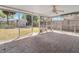 A screened-in back porch with a stone-patterned floor offers a tranquil outdoor space overlooking the backyard at 218 80Th N Ave, St Petersburg, FL 33702