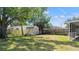 The backyard features a wooden storage shed and a well-maintained lawn, perfect for outdoor activities at 218 80Th N Ave, St Petersburg, FL 33702