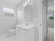 Clean bathroom with white vanity, toilet, tile floor, and neutral paint at 218 80Th N Ave, St Petersburg, FL 33702
