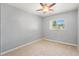 A modest, carpeted bedroom with a ceiling fan and a window providing natural light at 218 80Th N Ave, St Petersburg, FL 33702