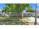 Charming single-story home with a well-maintained lawn, mature shade tree, and a sidewalk leading to the front door at 218 80Th N Ave, St Petersburg, FL 33702