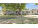 Charming single-story home with a large tree providing shade in the front yard at 218 80Th N Ave, St Petersburg, FL 33702