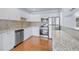 Updated kitchen featuring stainless steel appliances, granite countertops, and ample cabinet space at 218 80Th N Ave, St Petersburg, FL 33702