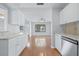 Bright and airy living room with hardwood floors as seen from the kitchen at 218 80Th N Ave, St Petersburg, FL 33702