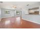 Bright living room with hardwood floors, ceiling fan, and pass through to kitchen at 218 80Th N Ave, St Petersburg, FL 33702