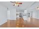 Open-concept living room view features hardwood floors, modern paint, and a ceiling fan at 218 80Th N Ave, St Petersburg, FL 33702