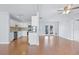 Open-concept living room boasts hardwood floors, lots of light, and flows into the kitchen at 218 80Th N Ave, St Petersburg, FL 33702
