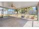 A screened patio with a fan, textured floor and plenty of natural light at 218 80Th N Ave, St Petersburg, FL 33702