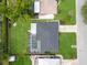Aerial view of the home showcasing the pool, screened enclosure, yard and roof at 2242 Sunnyside Ln, Sarasota, FL 34239