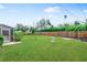 Green back yard with a wooden fence and manicured lawn at 2242 Sunnyside Ln, Sarasota, FL 34239