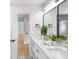 Well-lit bathroom with a double vanity, a large mirror, and contemporary decor accents at 2242 Sunnyside Ln, Sarasota, FL 34239