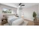 Serene bedroom with neutral tones, natural light, and a view into the modern kitchen at 2242 Sunnyside Ln, Sarasota, FL 34239