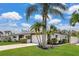 Beautiful home surrounded by palm trees, featuring a well-kept lawn and an attached two-car garage at 2242 Sunnyside Ln, Sarasota, FL 34239