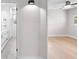 Hallway showcasing a bathroom with double vanity and bedroom with fan at 2242 Sunnyside Ln, Sarasota, FL 34239