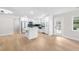 Bright kitchen area with stainless steel appliances, a center island, and hardwood floors at 2242 Sunnyside Ln, Sarasota, FL 34239