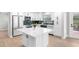 Well-lit kitchen featuring an island, stainless steel appliances, white cabinets, and sleek hardware at 2242 Sunnyside Ln, Sarasota, FL 34239