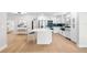 Open concept kitchen with a central island, stainless steel appliances, and modern white cabinetry at 2242 Sunnyside Ln, Sarasota, FL 34239