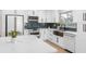 Modern kitchen with white cabinets, stainless steel appliances, and a beautiful backsplash at 2242 Sunnyside Ln, Sarasota, FL 34239