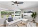Bright living room with large windows, comfortable seating, and views of the outdoor landscape at 2242 Sunnyside Ln, Sarasota, FL 34239