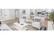 Stylish living room with hardwood floors and neutral decor, opening to the kitchen with breakfast bar seating at 2242 Sunnyside Ln, Sarasota, FL 34239