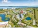 Property aerial view with a coastal backdrop and surrounding golf course, ponds, and a beautiful residential neighborhood at 2320 Terra Ceia Bay Blvd # 305, Palmetto, FL 34221