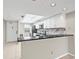Bright kitchen features white cabinets, black granite counters, stainless appliances, and a skylight at 2320 Terra Ceia Bay Blvd # 305, Palmetto, FL 34221