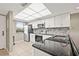 Modern kitchen with stainless steel appliances, white cabinetry, granite counters, and tile backsplash and floors at 2320 Terra Ceia Bay Blvd # 305, Palmetto, FL 34221