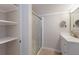 Clean bathroom featuring bright storage shelves, glass shower, and stylish vanity at 2601 Gulf N Dr # B24, Bradenton Beach, FL 34217