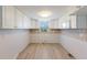 Bright kitchen area awaiting updates with white cabinets at 2601 Gulf N Dr # B24, Bradenton Beach, FL 34217