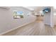 Open-concept living space with sleek wood flooring, modern fixtures and lots of natural light at 2601 Gulf N Dr # B24, Bradenton Beach, FL 34217