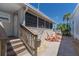Charming patio with stylish furniture, palm trees and serene views, ideal for relaxation and outdoor enjoyment at 2601 Gulf N Dr # B24, Bradenton Beach, FL 34217
