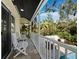 Charming balcony with comfortable seating, offering a serene outdoor retreat amid lush greenery and garden views at 3322 Bayou Rd, Longboat Key, FL 34228