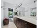 Bright bathroom featuring a long vanity with double sinks and access to outdoor area at 3322 Bayou Rd, Longboat Key, FL 34228