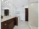 Bright bathroom featuring marble countertops, dark wood cabinetry, bathtub, and stand-up shower at 3322 Bayou Rd, Longboat Key, FL 34228