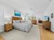 Bright bedroom featuring hardwood floors, natural wood furniture, and a comfortable bed at 3322 Bayou Rd, Longboat Key, FL 34228