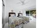 Bright bedroom showcasing two beds with floral quilts, ample natural light, and ceiling fan at 3322 Bayou Rd, Longboat Key, FL 34228