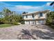 Beautiful two-story home featuring a three-car garage and a paved driveway at 3322 Bayou Rd, Longboat Key, FL 34228