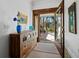 Inviting foyer with a wooden dresser and a view of the outdoor patio at 3322 Bayou Rd, Longboat Key, FL 34228