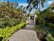 Inviting front entrance with lush landscaping and a brick pathway at 3322 Bayou Rd, Longboat Key, FL 34228