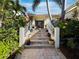 Beautiful home entrance with landscaped stairs and colorful flowers at 3322 Bayou Rd, Longboat Key, FL 34228