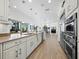 Expansive kitchen with stone countertops and modern stainless steel appliances at 3322 Bayou Rd, Longboat Key, FL 34228
