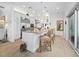 Bright, open kitchen featuring a large island with bar seating and stainless steel appliances at 3322 Bayou Rd, Longboat Key, FL 34228