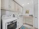 Well-equipped laundry room with ample cabinet space and modern appliances at 3322 Bayou Rd, Longboat Key, FL 34228