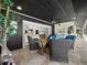 Outdoor patio with tiled flooring, comfortable seating, ceiling fan, and access to the living room via a sliding glass door at 3322 Bayou Rd, Longboat Key, FL 34228