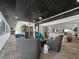 Covered patio with tiled floor, ceiling fan, comfortable seating, and sliding glass door into the living room at 3322 Bayou Rd, Longboat Key, FL 34228
