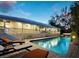 Inviting pool with sun loungers offers a serene outdoor retreat with views of the home's deck at 3322 Bayou Rd, Longboat Key, FL 34228