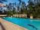Inviting pool area with water feature and lush tropical landscaping at 3322 Bayou Rd, Longboat Key, FL 34228
