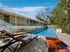 Inviting backyard pool with lounge chairs and lush landscaping, perfect for relaxation at 3322 Bayou Rd, Longboat Key, FL 34228