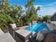 Secluded backyard pool featuring comfortable seating and mature landscaping at 3322 Bayou Rd, Longboat Key, FL 34228